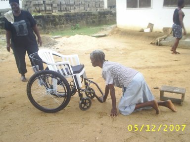 a woman getting to her wheelchair
