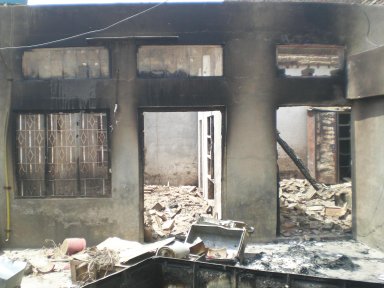 a burnt out Christian home in the village
