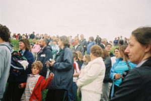 crowd watching river baptism