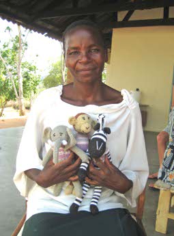 Sheila proudly holding the animals she has made