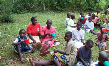 Children of Home of Hope sitting on grass