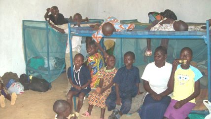 The orphan children sitting on some of the bunks